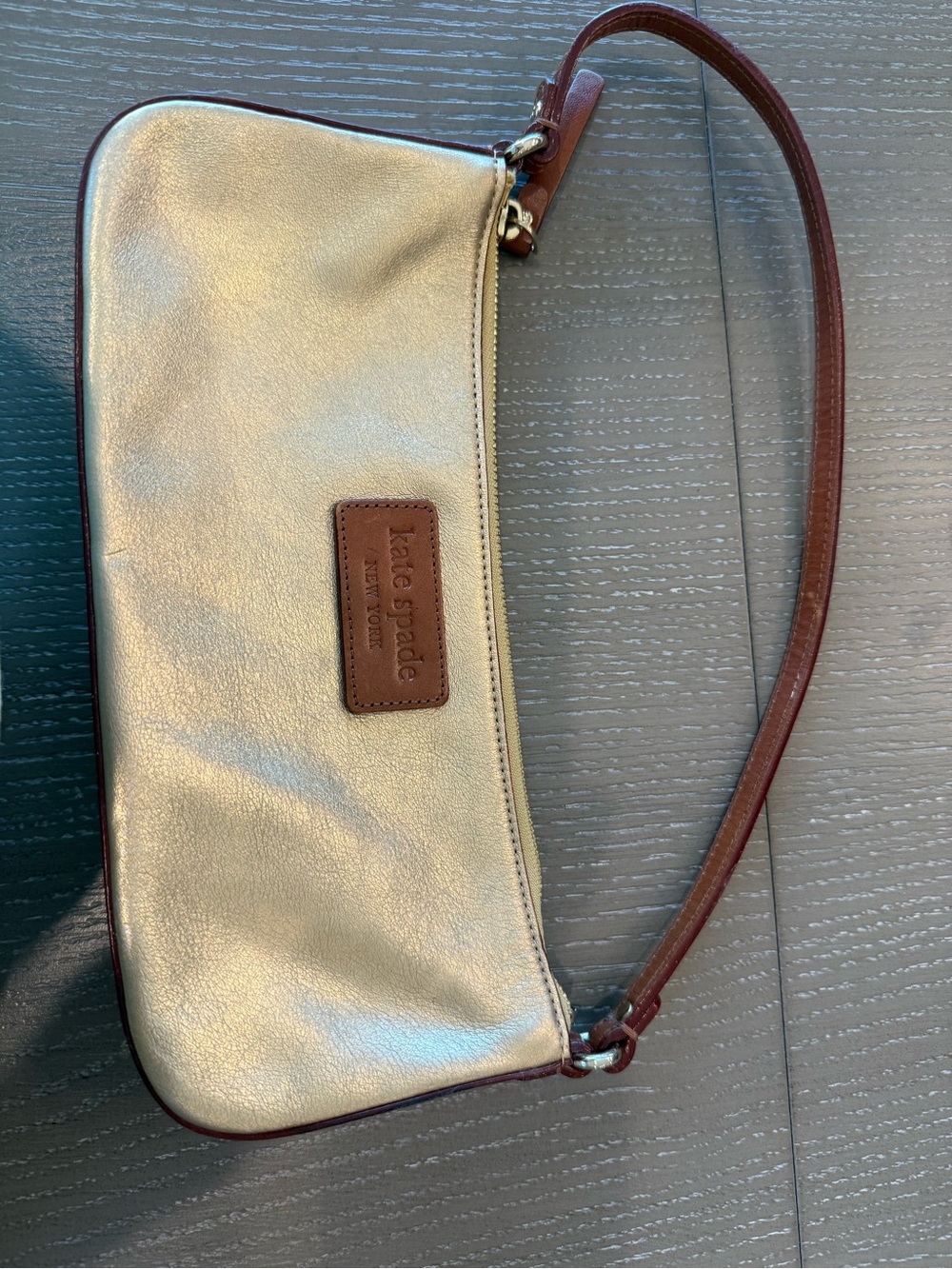 kate spade Metallic Gold Wristlet with Brown Leather Trim
